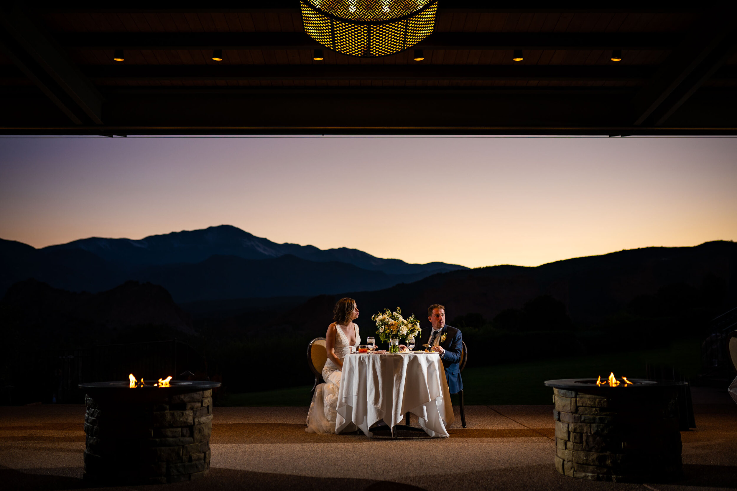 Bride and groom listen to speeches by family and friends during their wedding reception at the Garden of the Gods Club and resort by the reflection pond, wedding photos, wedding photography, wedding photographer, wedding inspiration, wedding photo inspiration, wedding portraits, wedding ceremony, wedding reception, mountain wedding, Garden of the Gods wedding, Garden of the Gods Club & Resort wedding, Garden of the Gods Club & Resort wedding photos, Garden of the Gods Club & Resort wedding photography, Garden of the Gods Club & Resort wedding photographer, Garden of the Gods Club & Resort wedding inspiration, Garden of the Gods Club & Resort wedding venue, Colorado Springs wedding, Colorado Springs wedding photos,  Colorado Springs wedding photography, Colorado Springs wedding photographer, Colorado wedding, Colorado wedding photos, Colorado wedding photography, Colorado wedding photographer, Colorado mountain wedding, Colorado wedding inspiration