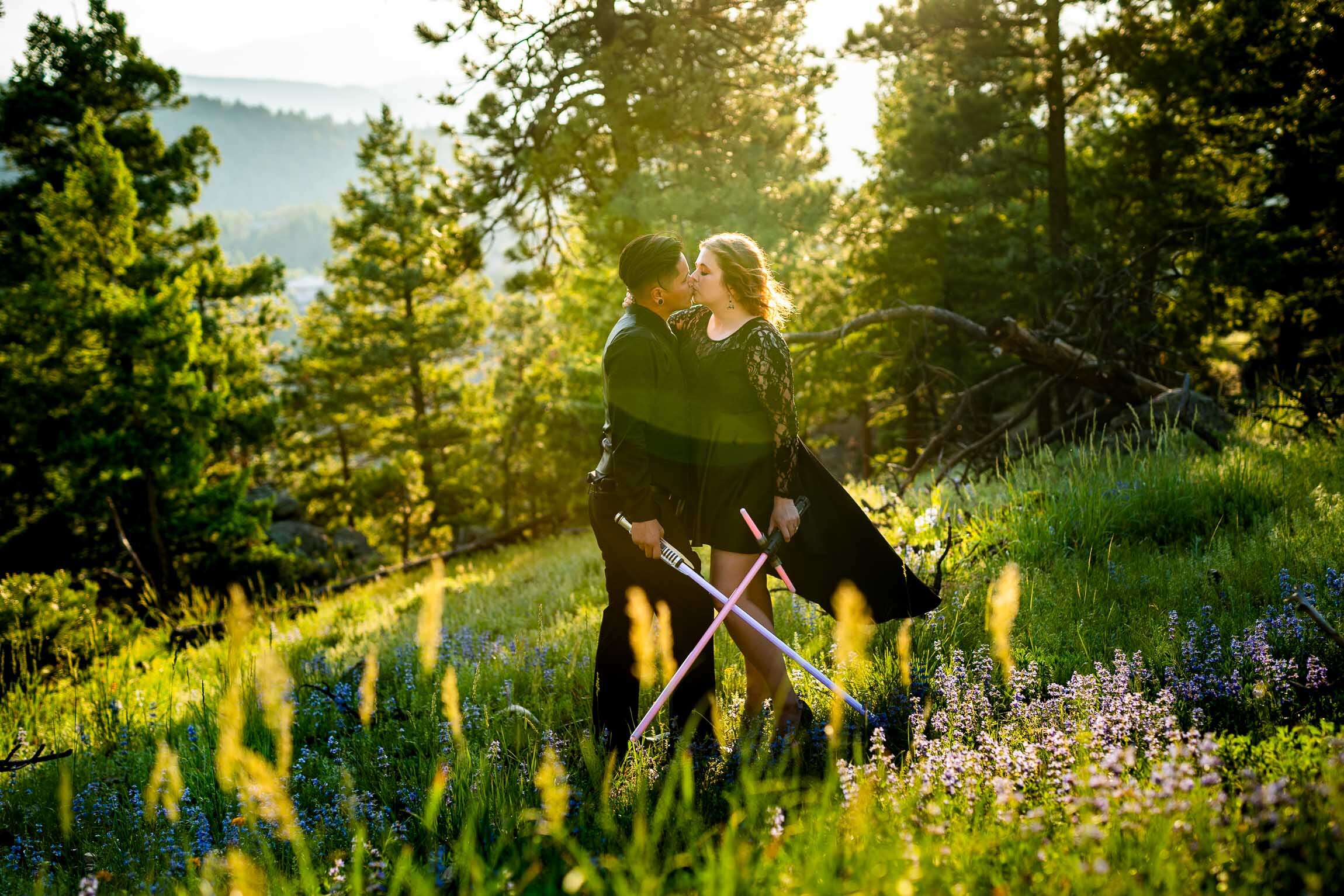 Engaged couple jumps into cosplay with their light sabers in the forest during golden hour, Engagement Session, Engagement Photos, Engagement Photos Inspiration, Engagement Photography, Engagement Photographer, Summer Engagement Photos, Mountain Engagement Photos, Lost Gulch Overlook engagement session, Lost Gulch Overlook engagement photos, Lost Gulch Overlook engagement photography, Lost Gulch Overlook engagement photographer, Lost Gulch Overlook  engagement inspiration, Boulder engagement session, Boulder engagement photos, Boulder engagement photography, Boulder engagement photographer, Boulder engagement inspiration, Colorado engagement session, Colorado engagement photos, Colorado engagement photography, Colorado engagement photographer, Colorado engagement inspiration