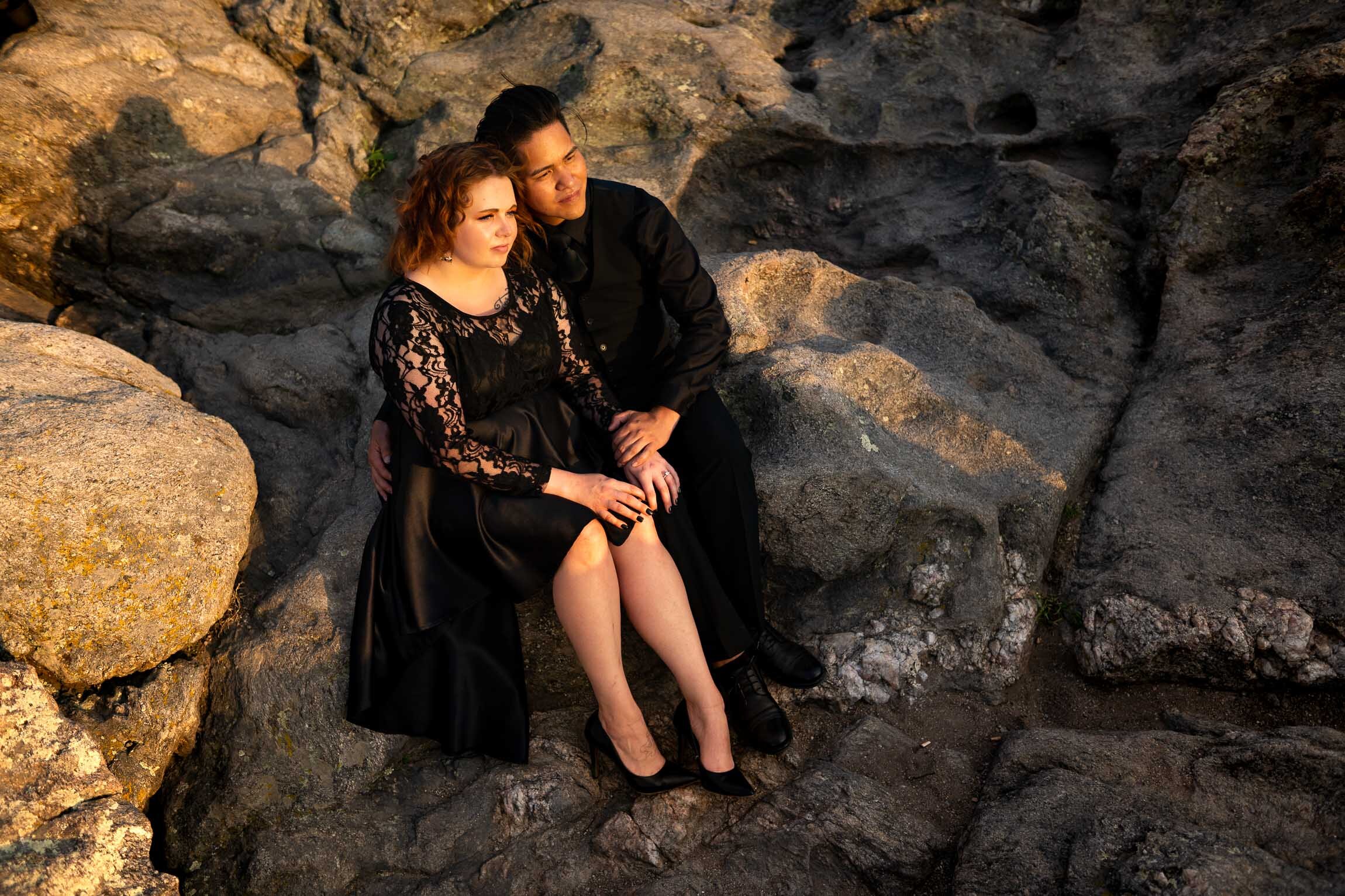 Engaged couple holds hands and watches the sun set from rocky ledge overlooking the mountains, Engagement Session, Sunset Engagement photos, Engagement Photos, Engagement Photos Inspiration, Engagement Photography, Engagement Photographer, Summer Engagement Photos, Mountain Engagement Photos, Lost Gulch Overlook engagement session, Lost Gulch Overlook engagement photos, Lost Gulch Overlook engagement photography, Lost Gulch Overlook engagement photographer, Lost Gulch Overlook  engagement inspiration, Boulder engagement session, Boulder engagement photos, Boulder engagement photography, Boulder engagement photographer, Boulder engagement inspiration, Colorado engagement session, Colorado engagement photos, Colorado engagement photography, Colorado engagement photographer, Colorado engagement inspiration