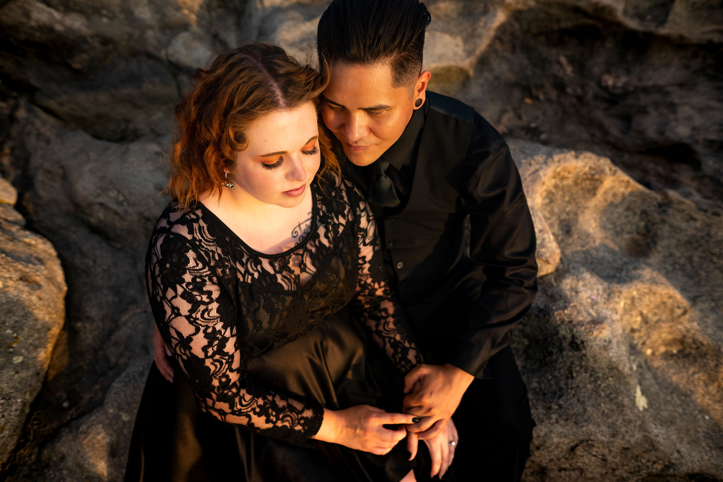 Engaged couple holds hands and watches the sun set from rocky ledge overlooking the mountains, Engagement Session, Sunset Engagement photos, Engagement Photos, Engagement Photos Inspiration, Engagement Photography, Engagement Photographer, Summer Engagement Photos, Mountain Engagement Photos, Lost Gulch Overlook engagement session, Lost Gulch Overlook engagement photos, Lost Gulch Overlook engagement photography, Lost Gulch Overlook engagement photographer, Lost Gulch Overlook  engagement inspiration, Boulder engagement session, Boulder engagement photos, Boulder engagement photography, Boulder engagement photographer, Boulder engagement inspiration, Colorado engagement session, Colorado engagement photos, Colorado engagement photography, Colorado engagement photographer, Colorado engagement inspiration