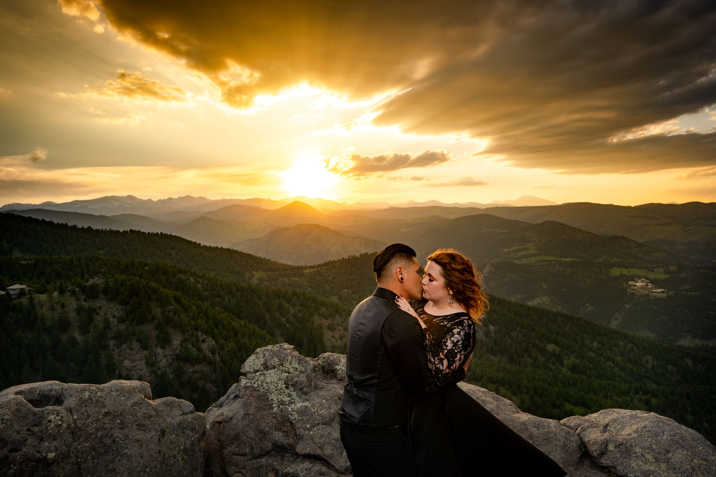 Engaged couple holds hands and watches the sun set from rocky ledge overlooking the mountains, Engagement Session, Sunset Engagement photos, Engagement Photos, Engagement Photos Inspiration, Engagement Photography, Engagement Photographer, Summer Engagement Photos, Mountain Engagement Photos, Lost Gulch Overlook engagement session, Lost Gulch Overlook engagement photos, Lost Gulch Overlook engagement photography, Lost Gulch Overlook engagement photographer, Lost Gulch Overlook  engagement inspiration, Boulder engagement session, Boulder engagement photos, Boulder engagement photography, Boulder engagement photographer, Boulder engagement inspiration, Colorado engagement session, Colorado engagement photos, Colorado engagement photography, Colorado engagement photographer, Colorado engagement inspiration