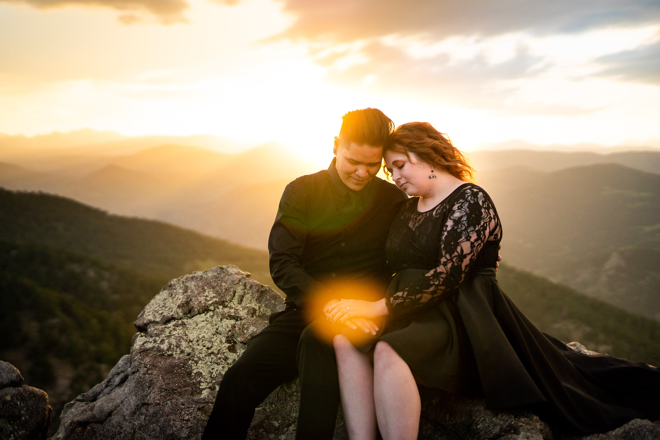 Engaged couple holds hands and watches the sun set from rocky ledge overlooking the mountains, Engagement Session, Sunset Engagement photos, Engagement Photos, Engagement Photos Inspiration, Engagement Photography, Engagement Photographer, Summer Engagement Photos, Mountain Engagement Photos, Lost Gulch Overlook engagement session, Lost Gulch Overlook engagement photos, Lost Gulch Overlook engagement photography, Lost Gulch Overlook engagement photographer, Lost Gulch Overlook  engagement inspiration, Boulder engagement session, Boulder engagement photos, Boulder engagement photography, Boulder engagement photographer, Boulder engagement inspiration, Colorado engagement session, Colorado engagement photos, Colorado engagement photography, Colorado engagement photographer, Colorado engagement inspiration