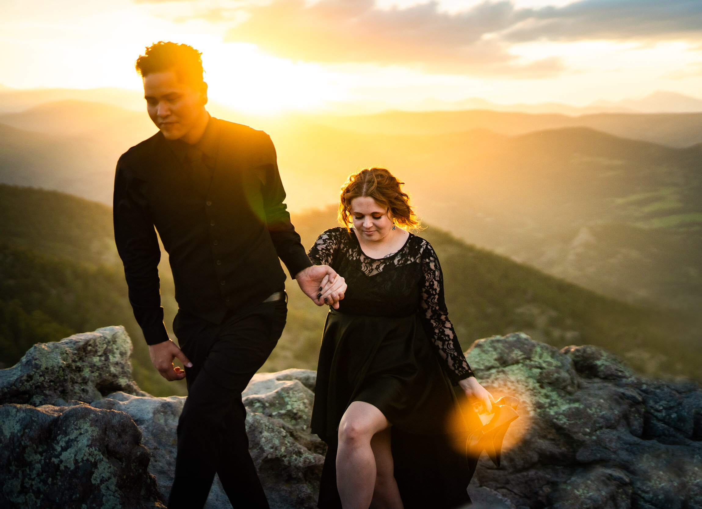 Engaged couple holds hands and watches the sun set from rocky ledge overlooking the mountains, Engagement Session, Sunset Engagement photos, Engagement Photos, Engagement Photos Inspiration, Engagement Photography, Engagement Photographer, Summer Engagement Photos, Mountain Engagement Photos, Lost Gulch Overlook engagement session, Lost Gulch Overlook engagement photos, Lost Gulch Overlook engagement photography, Lost Gulch Overlook engagement photographer, Lost Gulch Overlook  engagement inspiration, Boulder engagement session, Boulder engagement photos, Boulder engagement photography, Boulder engagement photographer, Boulder engagement inspiration, Colorado engagement session, Colorado engagement photos, Colorado engagement photography, Colorado engagement photographer, Colorado engagement inspiration