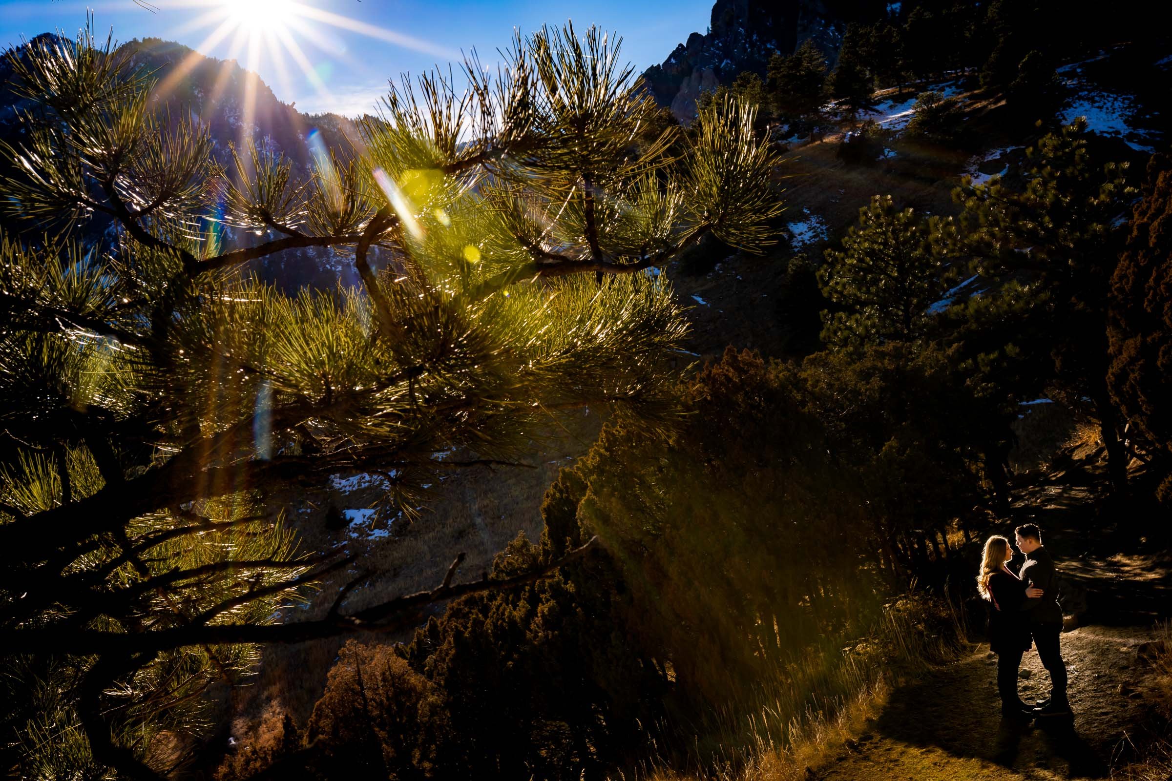 Engaged couple poses for portraits with the flatirons mountains in the background, Mountain Engagement Photos, Engagement Session, Engagement Photos, Engagement Photos Inspiration, Engagement Photography, Engagement Photographer, Engagement Portraits, Winter Engagement Photos, Snow Engagement Photos, Boulder engagement session, Boulder engagement photos, Boulder engagement photography, Boulder engagement photographer, Boulder engagement inspiration, NCAR Trail engagement session, NCAR Trail engagement photos, NCAR Trail engagement photography, NCAR Trail engagement photographer, NCAR Trail engagement inspiration, Colorado engagement session, Colorado engagement photos, Colorado engagement photography, Colorado engagement photographer, Colorado engagement inspiration